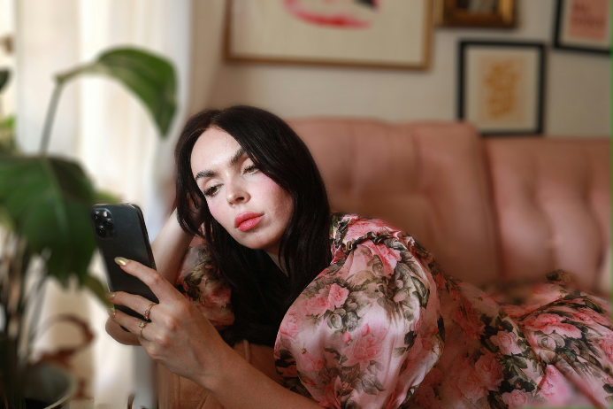 Woman scrolling on her phone, frozen mid-task